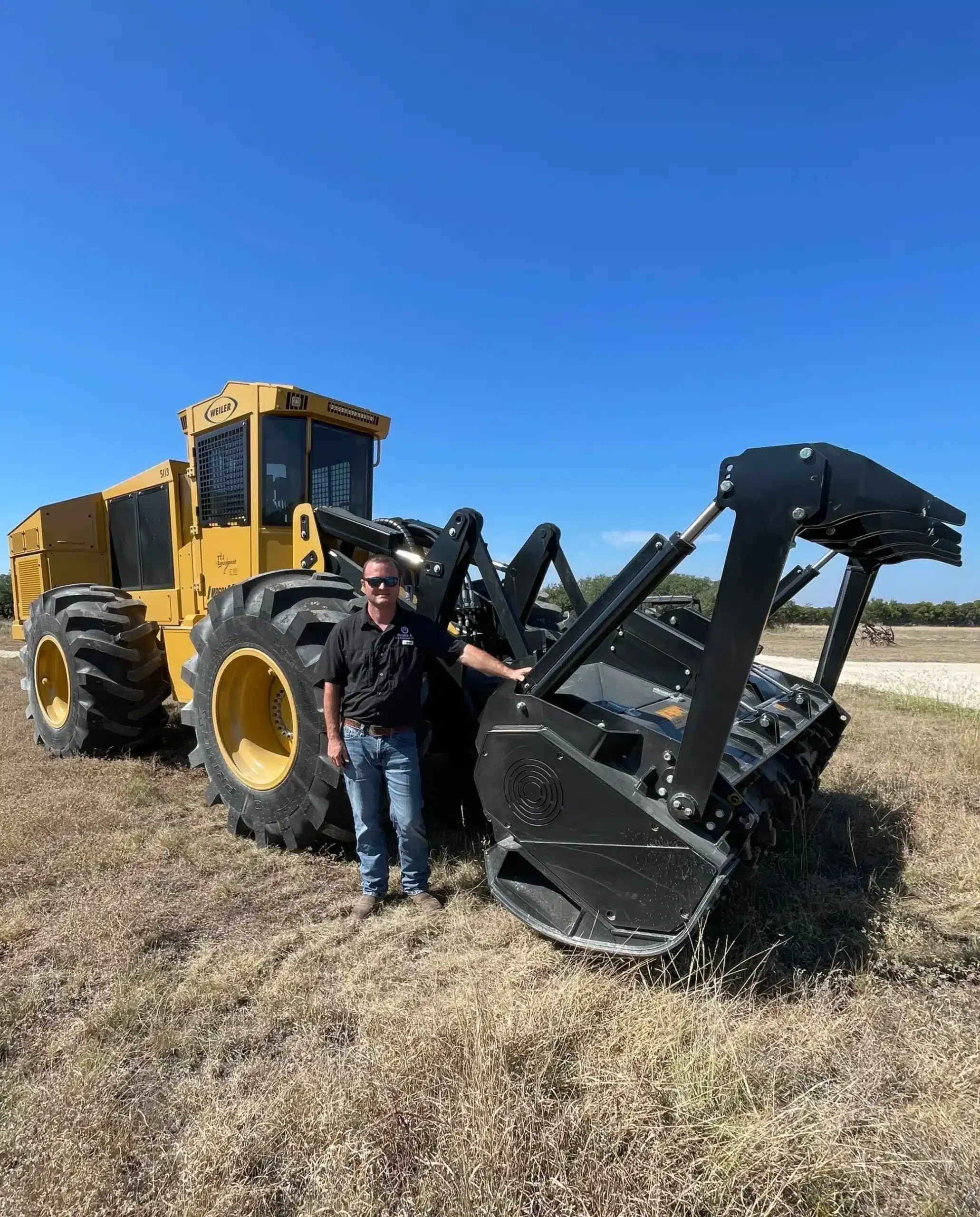 Forestry mulcher with operator on cleared rural land