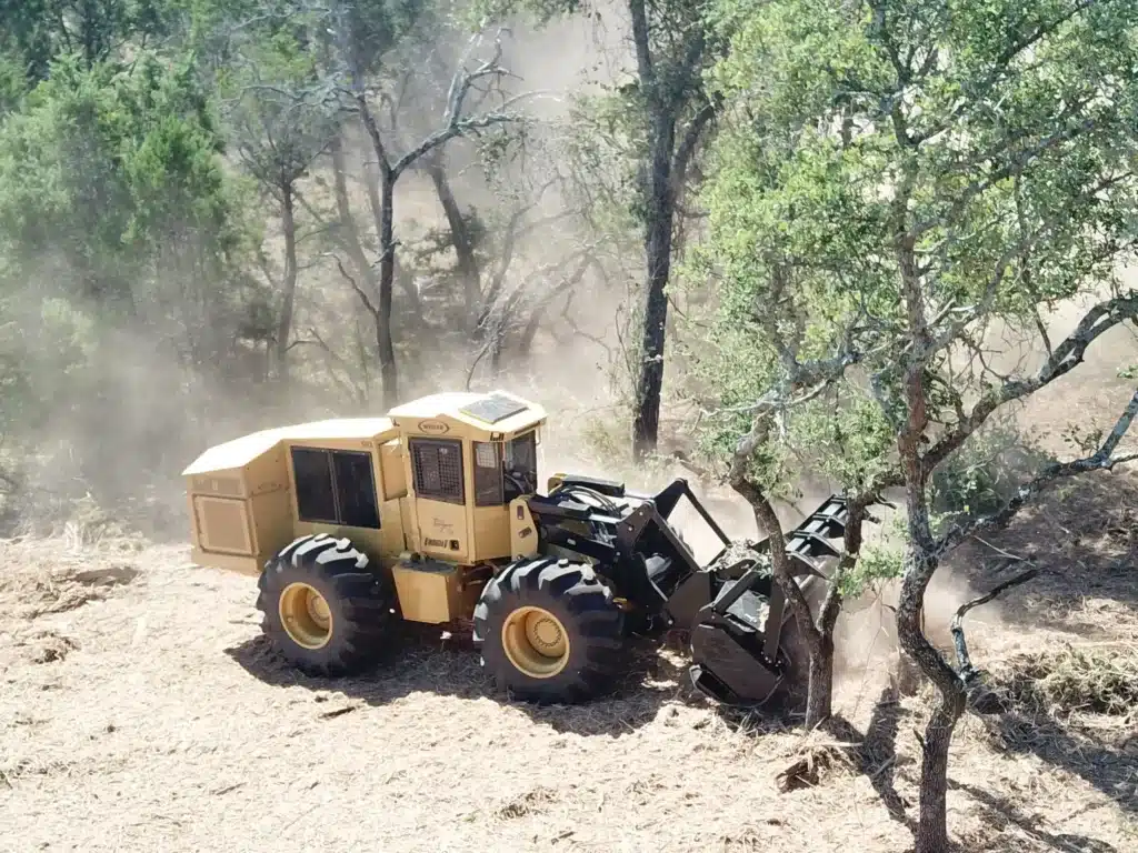 Forestry mulcher grinding trees professional land clearing